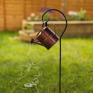 Cascading LED strands glowing from a garden watering can