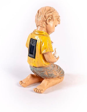 Solar garden figure illuminated with a warm glow