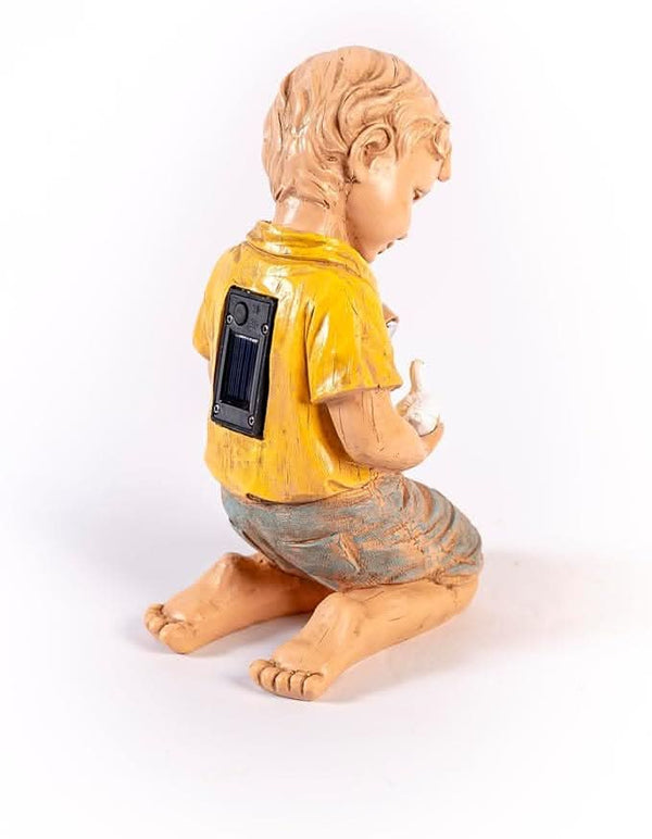 Solar garden figure illuminated with a warm glow