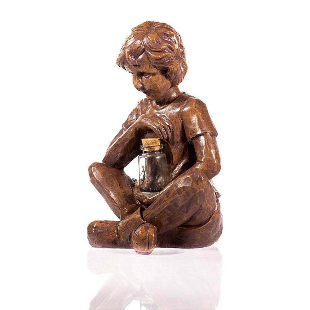 Solar boy garden ornament holding glowing firefly jar
