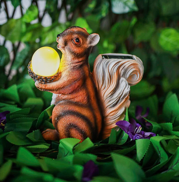Solar squirrel decoration displayed in a flower bed