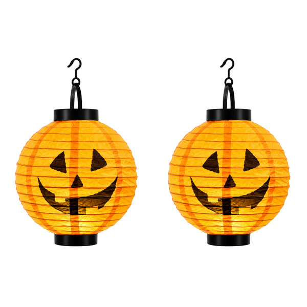 Two orange paper lanterns shaped like pumpkins with black jack-o'-lantern faces, each hanging from a black hook on a white background.
