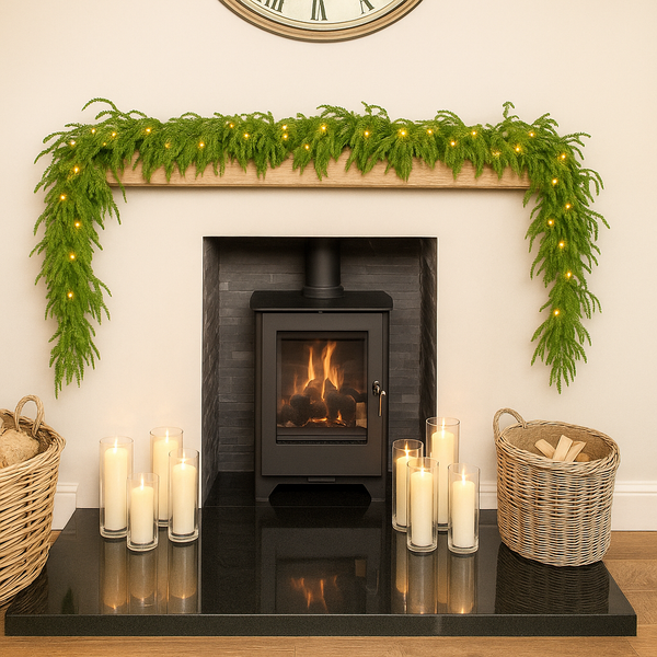 Decorative fireplace with greenery, candles, and baskets in a cozy room.