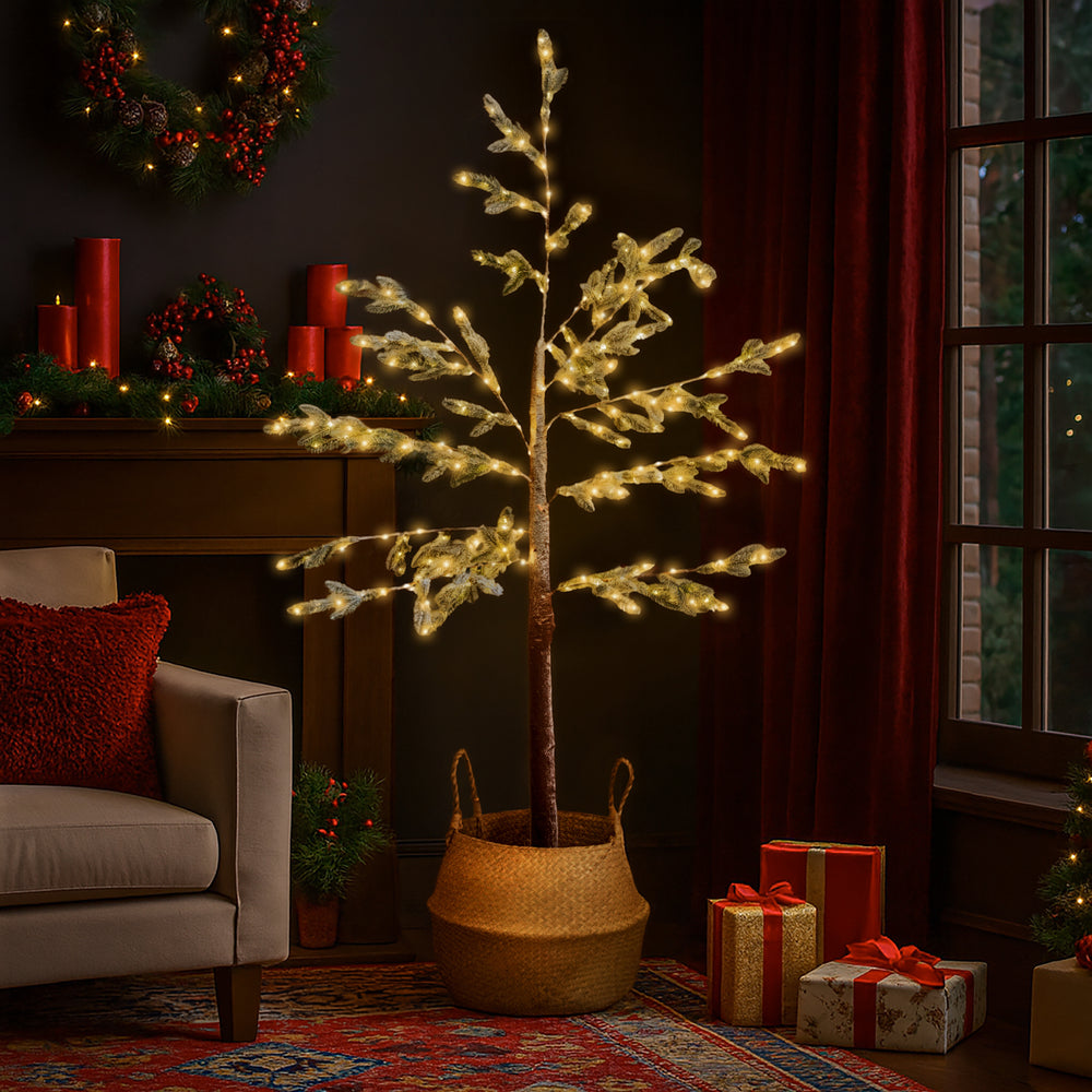 Decorative indoor tree with lights in a living room setting with Christmas decorations.