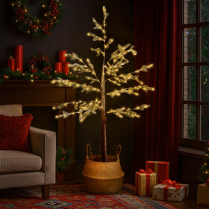 Decorative indoor tree with lights in a living room setting with Christmas decorations.