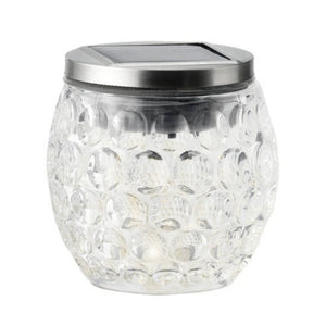 Glass jar with solar panel on top on a white background