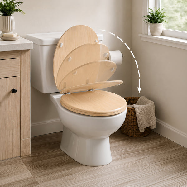 A close-up of a toilet with a light natural wood seat and lid, shown in a bright bathroom setting. A dashed arrow graphic points from the open lid to the closed seat, illustrating the product's function.