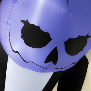 A close-up of a large inflatable pumpkin decoration with a purple body, black carved facial features, and a white base.