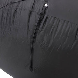 Close-up of a black waterproof fabric cover with a central zipper and a white snap button, showing the textured material and folds.