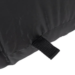Close-up of a black fabric item with a stitched seam and a black hook-and-loop strap tab, shown against a white background.