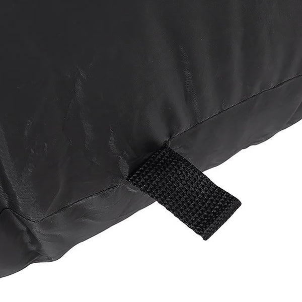 Close-up of a black fabric item with a stitched seam and a black hook-and-loop strap tab, shown against a white background.