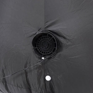 Close-up of a dark gray waterproof tent fabric with a circular ventilation mesh opening and a white grommet.