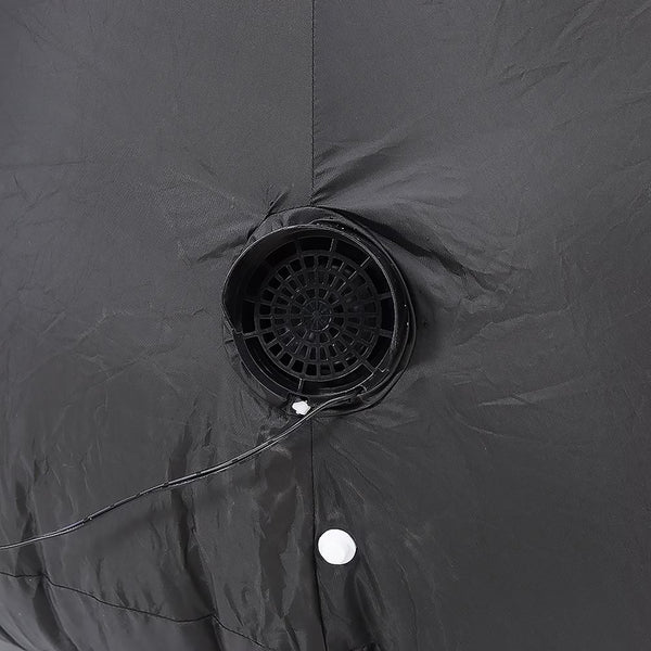 Close-up of a dark gray waterproof tent fabric with a circular ventilation mesh opening and a white grommet.