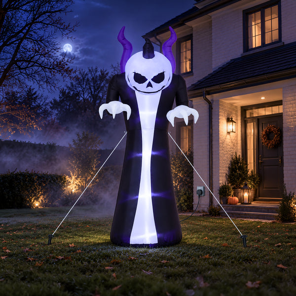 An inflatable Halloween yard decoration shaped like a skull-faced demon in a long black robe with purple horns, displayed on a lawn in front of a house at night.