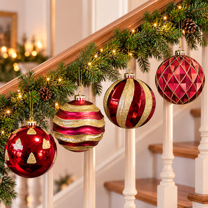 Extra large red and gold Christmas baubles hanging from a wooden staircase decorated with festive greenery.
