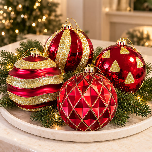 Set of four red and gold Christmas tree baubles arranged in a decorative bowl for a festive centrepiece.