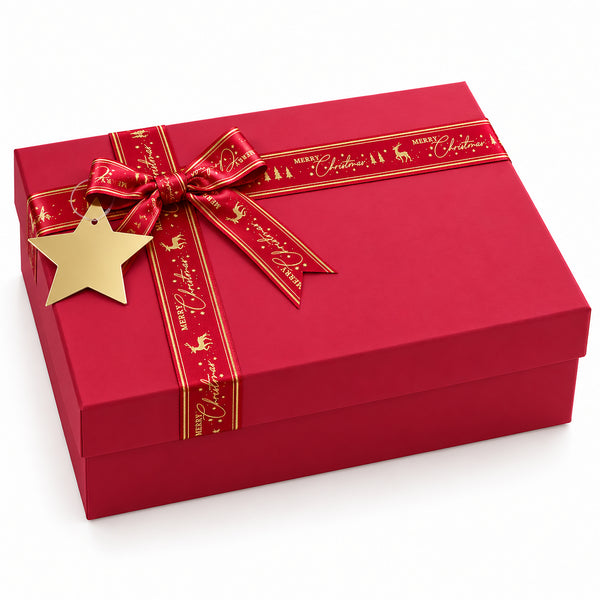A red square gift box with a matching red ribbon tied in a bow, decorated with gold script and holiday motifs, and a gold star tag, photographed on a clean white background.