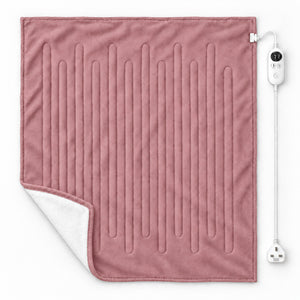 A dusty pink heated blanket with vertical channel stitching, showing a white sherpa lining on the corner, with its white power cord and controller on a clean white background.
