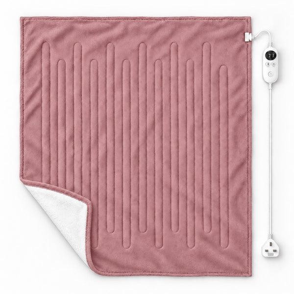 A dusty pink heated blanket with vertical channel stitching, showing a white sherpa lining on the corner, with its white power cord and controller on a clean white background.