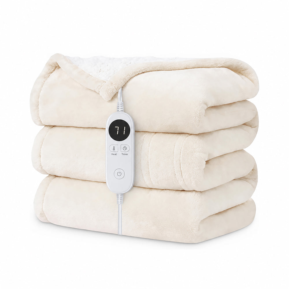 A cream-colored fleece blanket draped over a beige armchair in a cozy living room setting, with a white wired electric heater controller resting on the armrest.