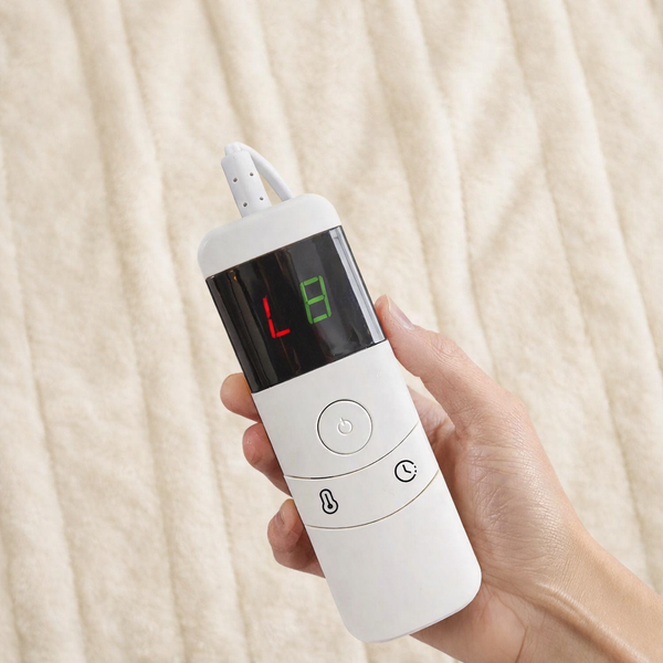 A hand holding a white electronic nasal mist pump device with a digital display screen showing 'L8' in red and green, set against a soft beige textured blanket background.