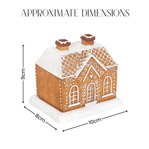 A gingerbread house decoration shown with overlaid dimension arrows and labels reading 9 cm tall, 8 cm wide, and 10 cm deep, under the heading 'APPROXIMATE DIMENSIONS' on a white background.