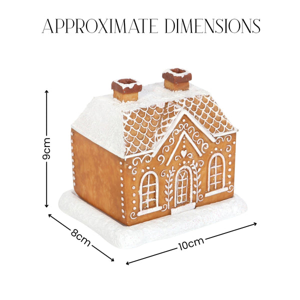 A gingerbread house decoration shown with overlaid dimension arrows and labels reading 9 cm tall, 8 cm wide, and 10 cm deep, under the heading 'APPROXIMATE DIMENSIONS' on a white background.