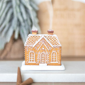 Decorative gingerbread house with white icing on a blurred background