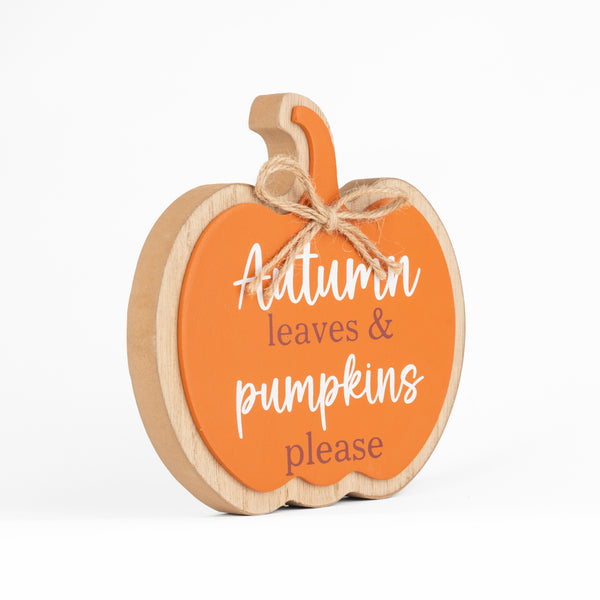 A decorative wooden pumpkin sign with an orange face, natural wood edges, and a jute twine bow. The sign features the text 'Autumn leaves & pumpkins please' in white and brown lettering, set against a clean white background.
