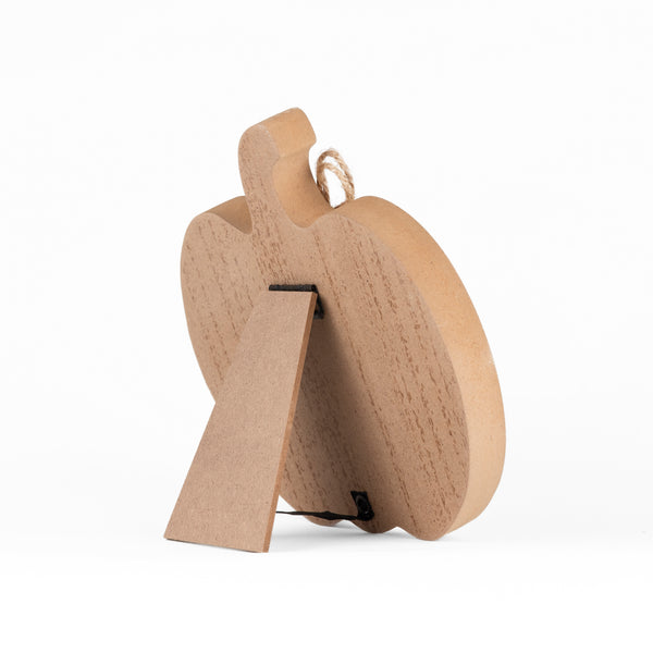A small natural wood decorative object with a rounded, sculptural shape, a hanging loop at the top, and a small rectangular support tab, photographed on a clean white background.