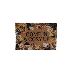 A rectangular doormat with a natural coir background and a border of autumn leaves in brown, beige, and black. The words 'COME IN & COSY UP' are printed in black in the center.