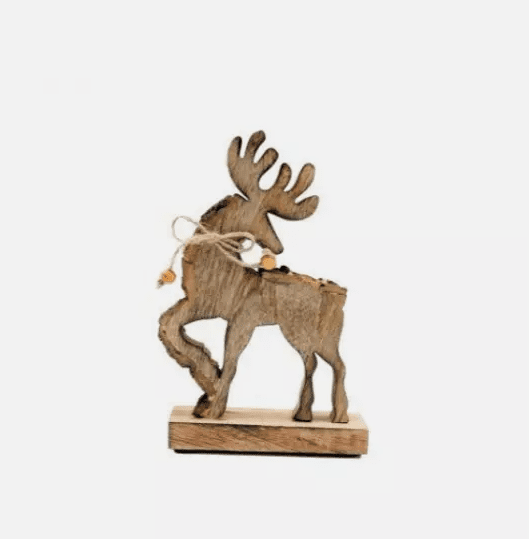 A wooden reindeer Christmas ornament placed on a surface with a blurred background, illuminated by a warm light.