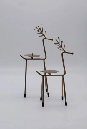 Decorative metal reindeer figures on a white background