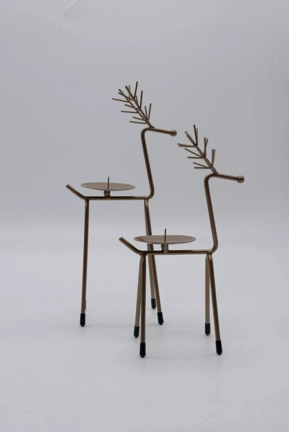 Decorative metal reindeer figures on a white background