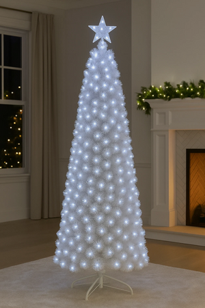 White Christmas tree with lights and a star on top in a room with a fireplace and window.