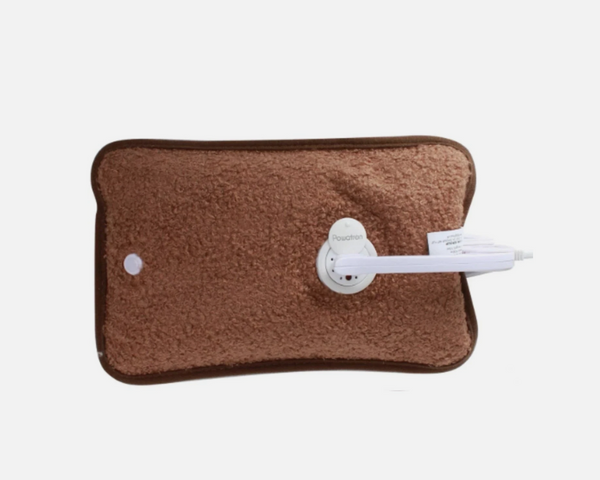 Brown electric heating pad with white plug on a white background