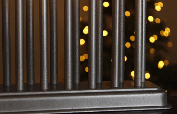 Metallic radiator with blurred lights in the background