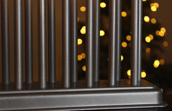 Metallic cylindrical object with a blurred background of lights