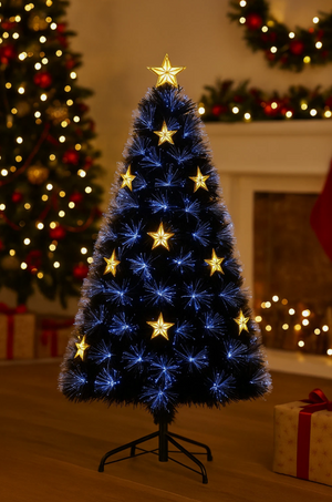 Fibre optic Christmas tree with cool white lights and light up gold stars, in front of a lit fireplace in a livingroom.
