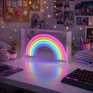 Neon rainbow light on a desk with colorful decor
