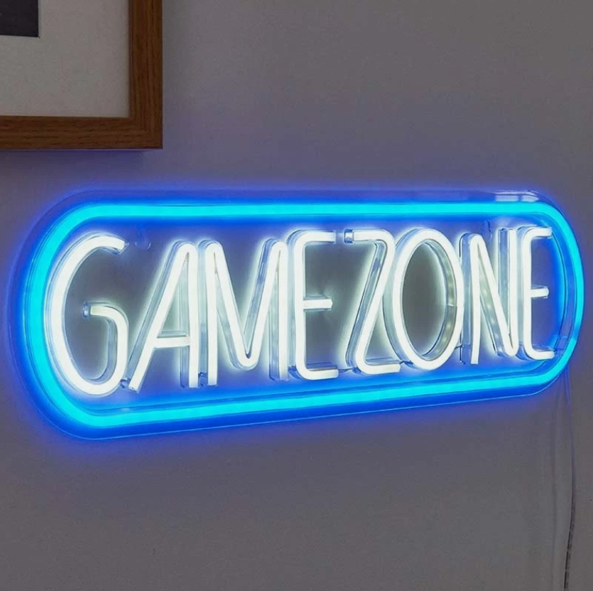 Neon sign with 'GAMEZONE' text on a white wall