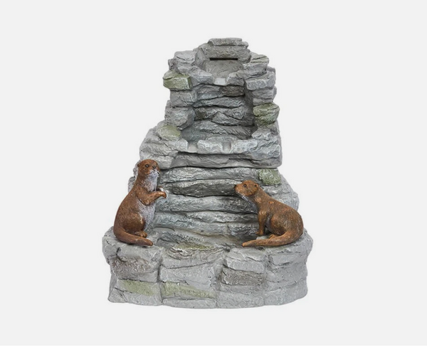 Decorative stone structure with two small animals on a white background
