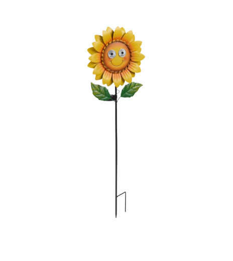 Sunflower-shaped garden stake with a smiley face in a garden setting