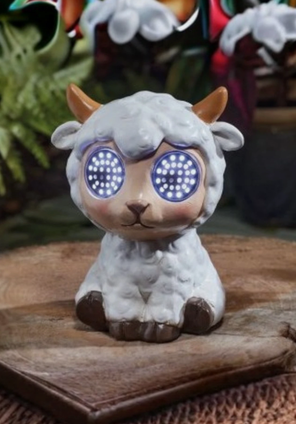 Small figurine of a lamb with glowing blue eyes on a wooden surface.