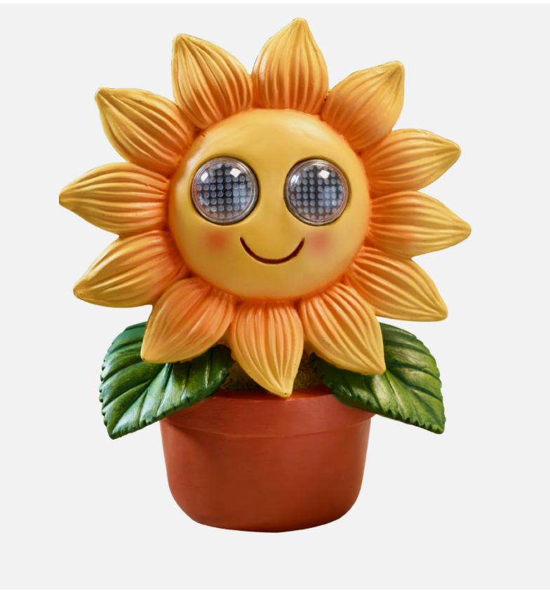 Sunflower-shaped decorative light with a smiling face on a blurred background