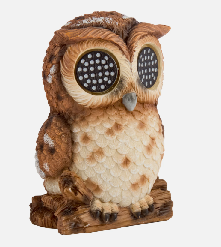 Solar-powered owl with LED eyes on a wooden surface
