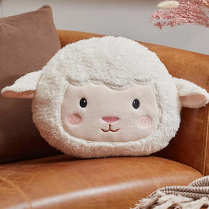 Plush lamb pillow on a brown couch