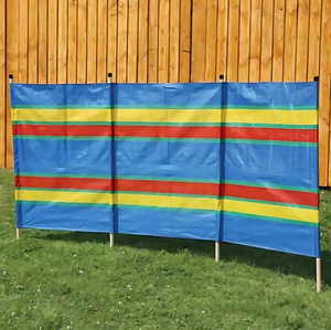 Colorful striped privacy screen against a wooden fence