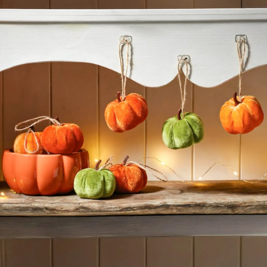 Decorative pumpkins on a wooden surface with a warm glow