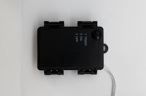 Black electronic device with buttons and a timer display on a white background